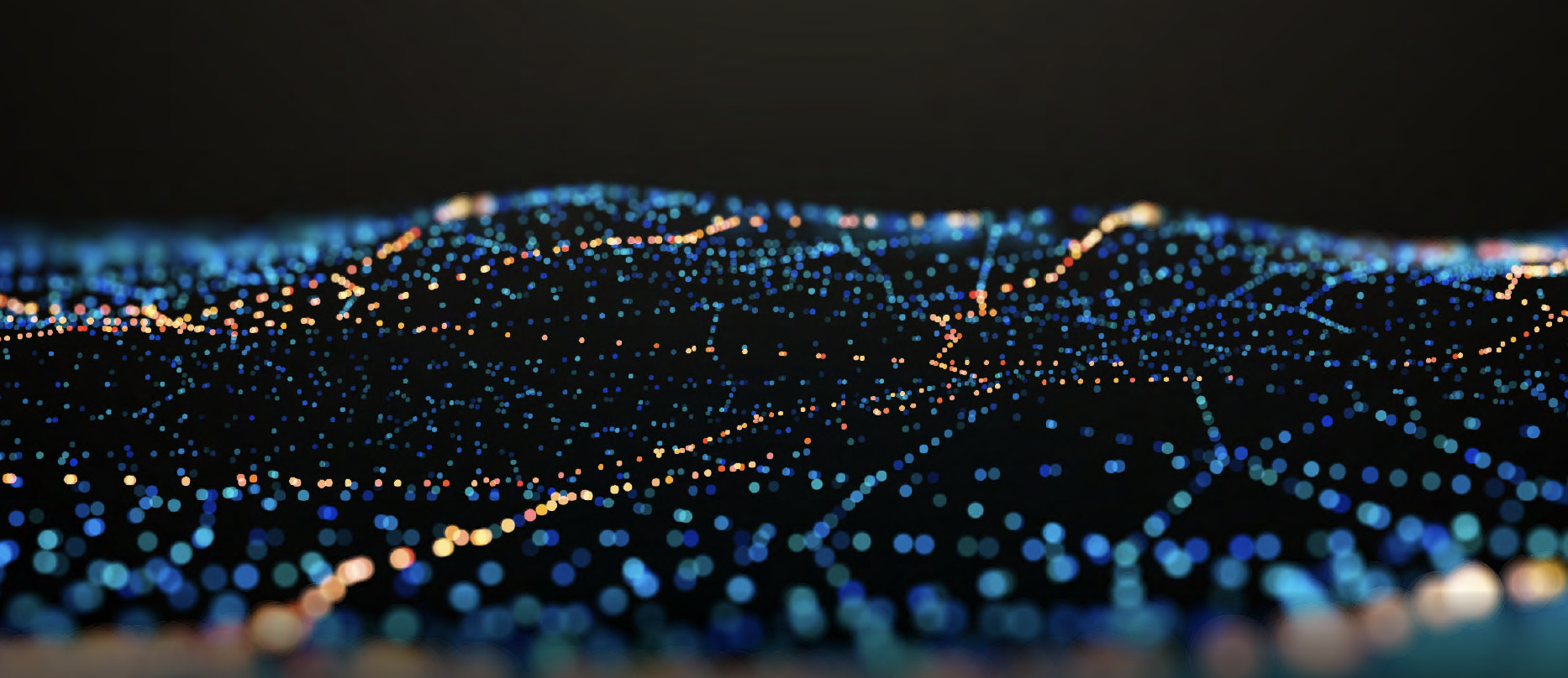 Abstract imagery featuring a gridwork of blue, orange, and white lights over a dark background