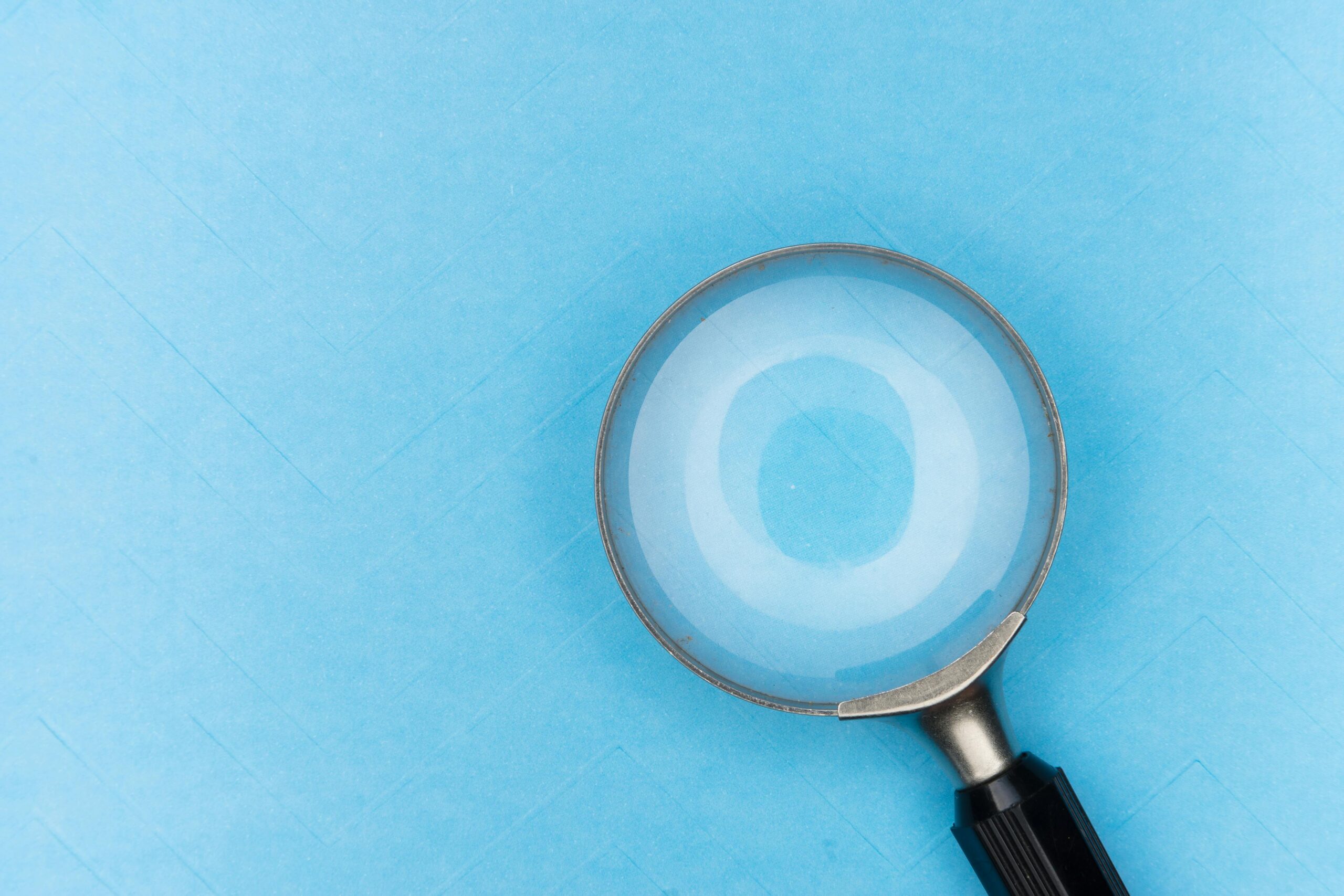 magnifying glass against a light blue background
