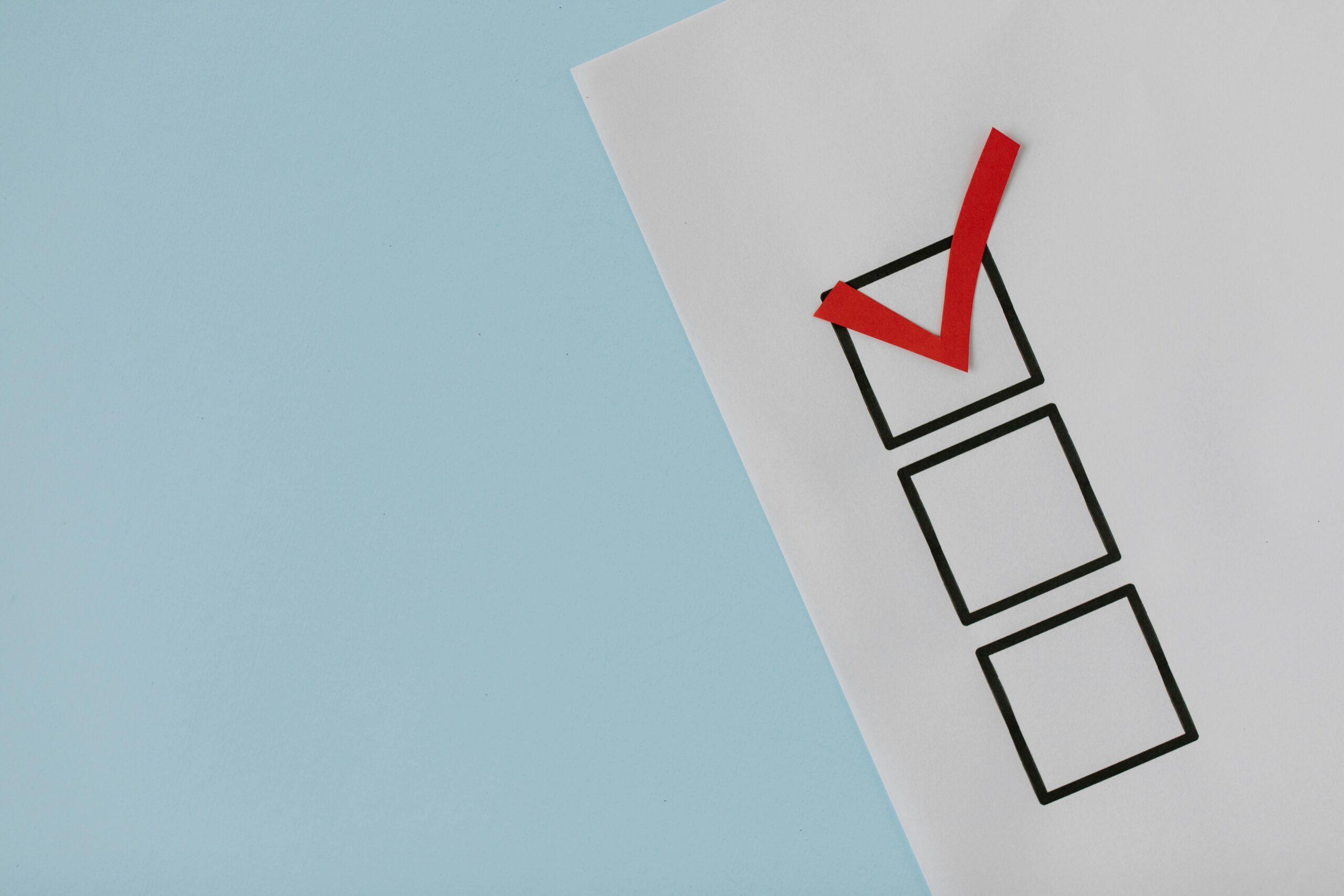 Stock photo of a checklist with three non-specific items, one of which is checked off with a red check mark