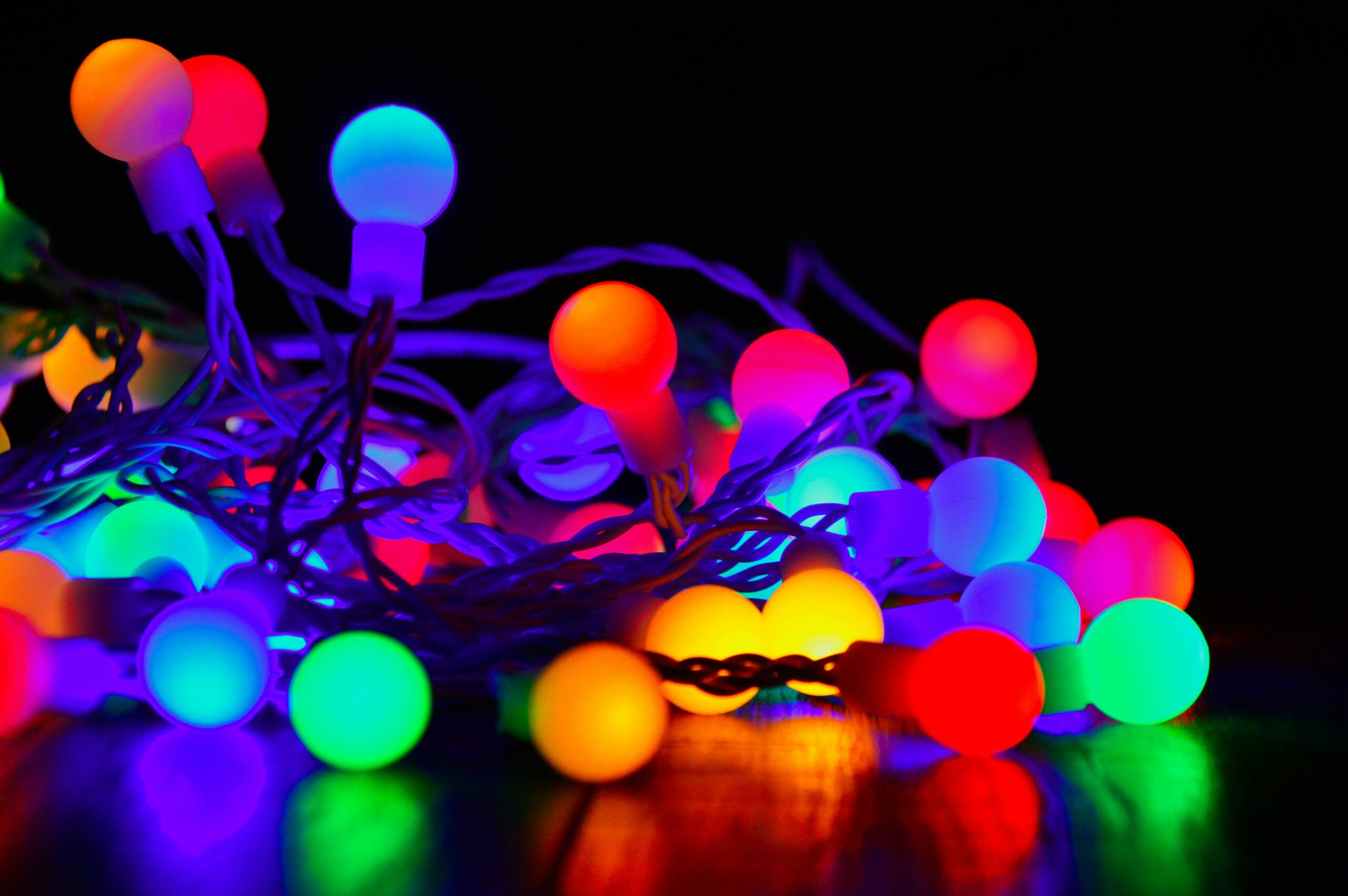 Close up stock photo of illuminated, extra large Christmas light bulbs in multicolor