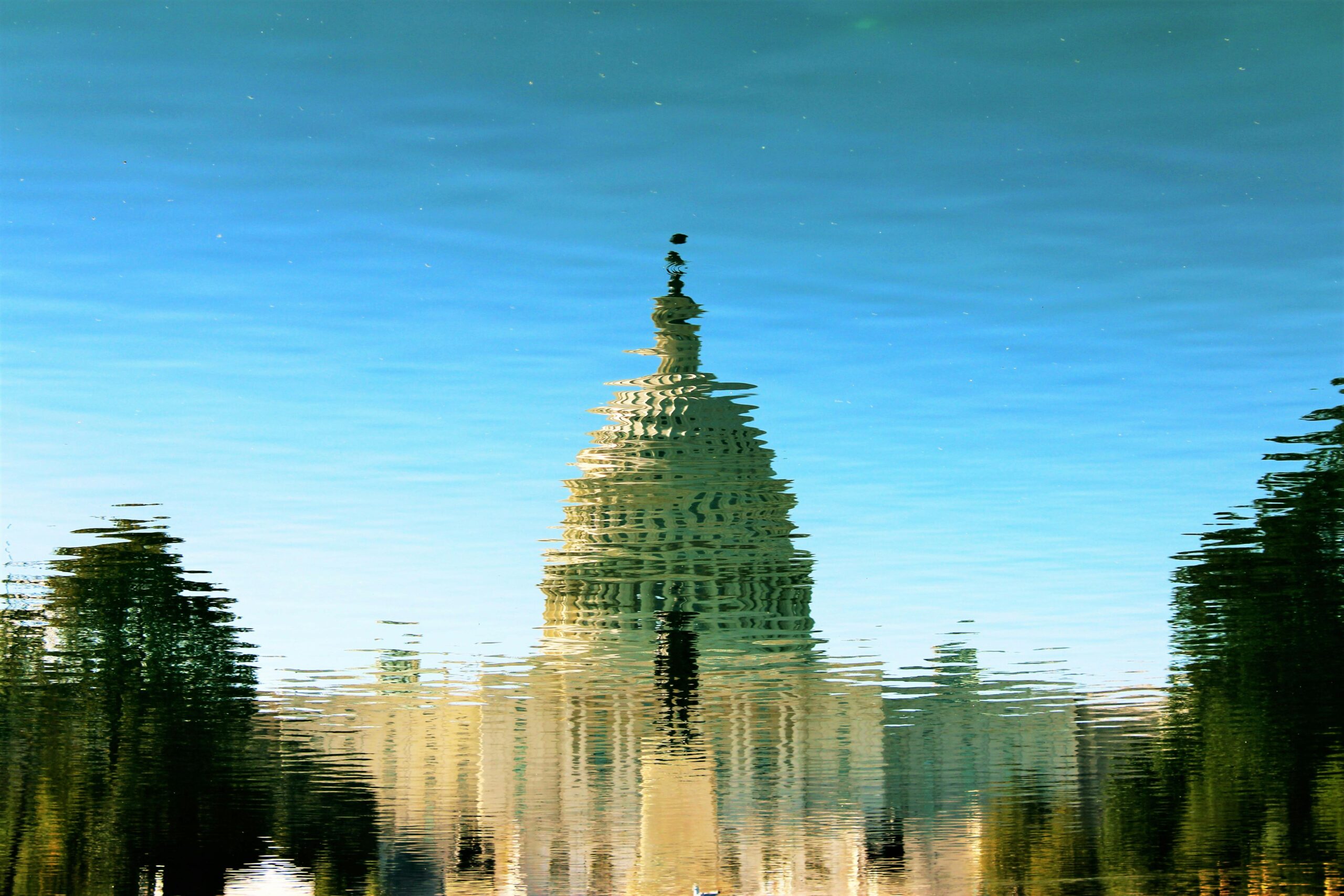 Distorted or pixellated image showing the US capitol building from a distance against a blue sky